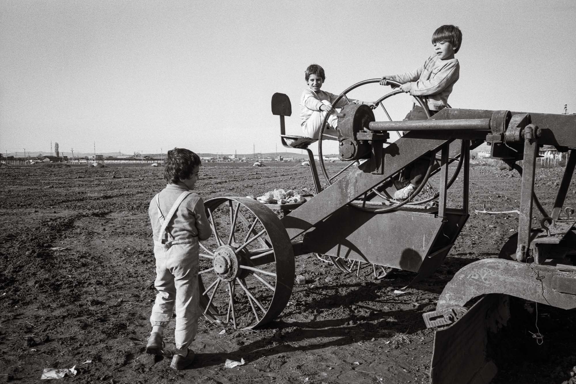 Bart-Deseyn-photographer-albania-1992-18 Boys playing on farm equipment photographed in 1992 in Albania, Durrës region
