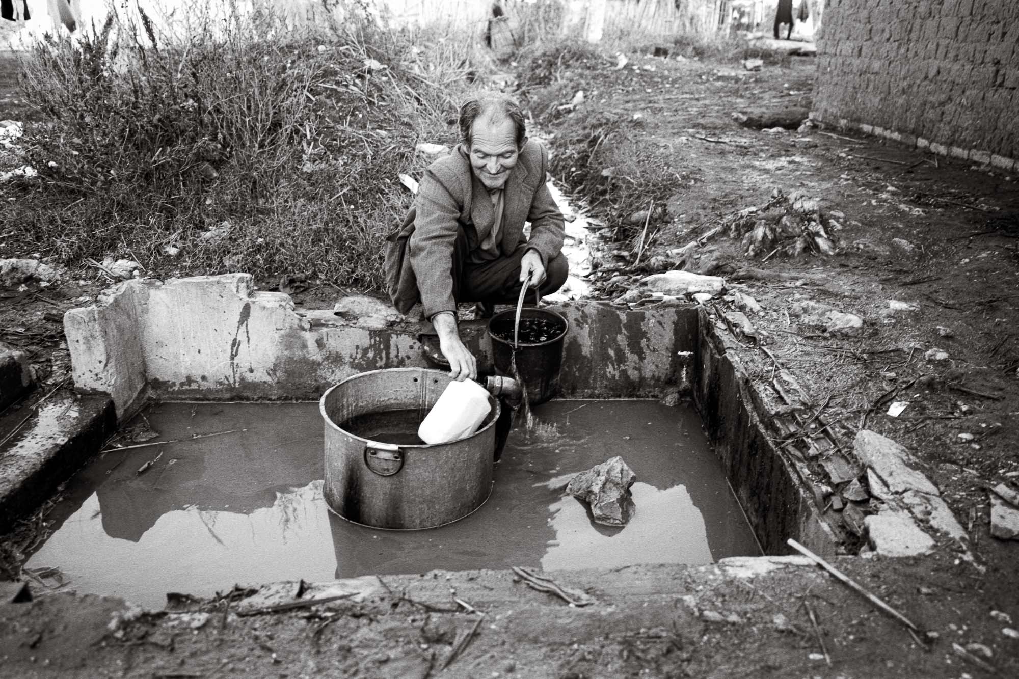 Bart-Deseyn-photographer-albania-1992-29 Man fetching water in a well in a former labour camp photographed in 1992 in Albania, Berat Region
