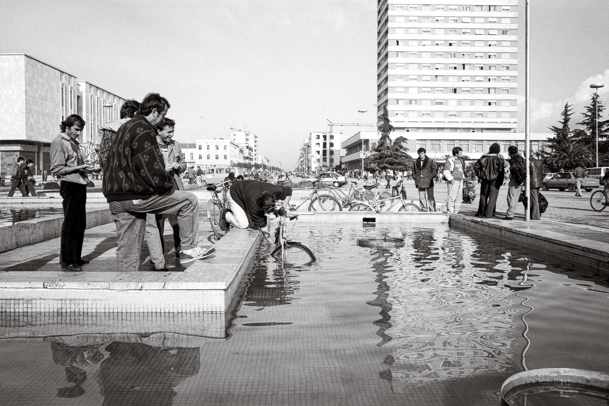 Bart-Deseyn-photographer-albania-1992-30 Man washing his bike in the fountain on the central square in Tirana photographed in 1992 in Albania, Tirana